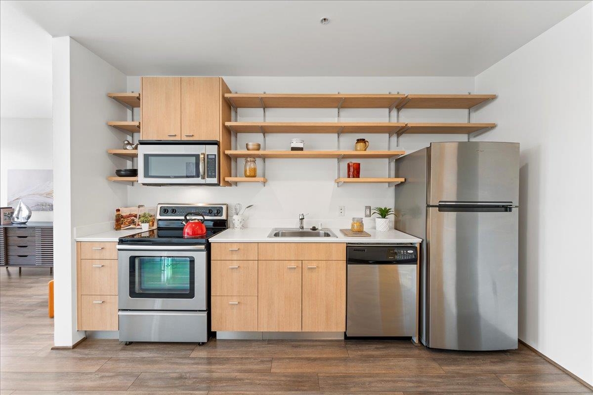 1201 Pine Street, Unit 365 Oakland, CA 94607 - Photo 12 of 33 a kitchen with stainless steel appliances a refrigerator and a stove