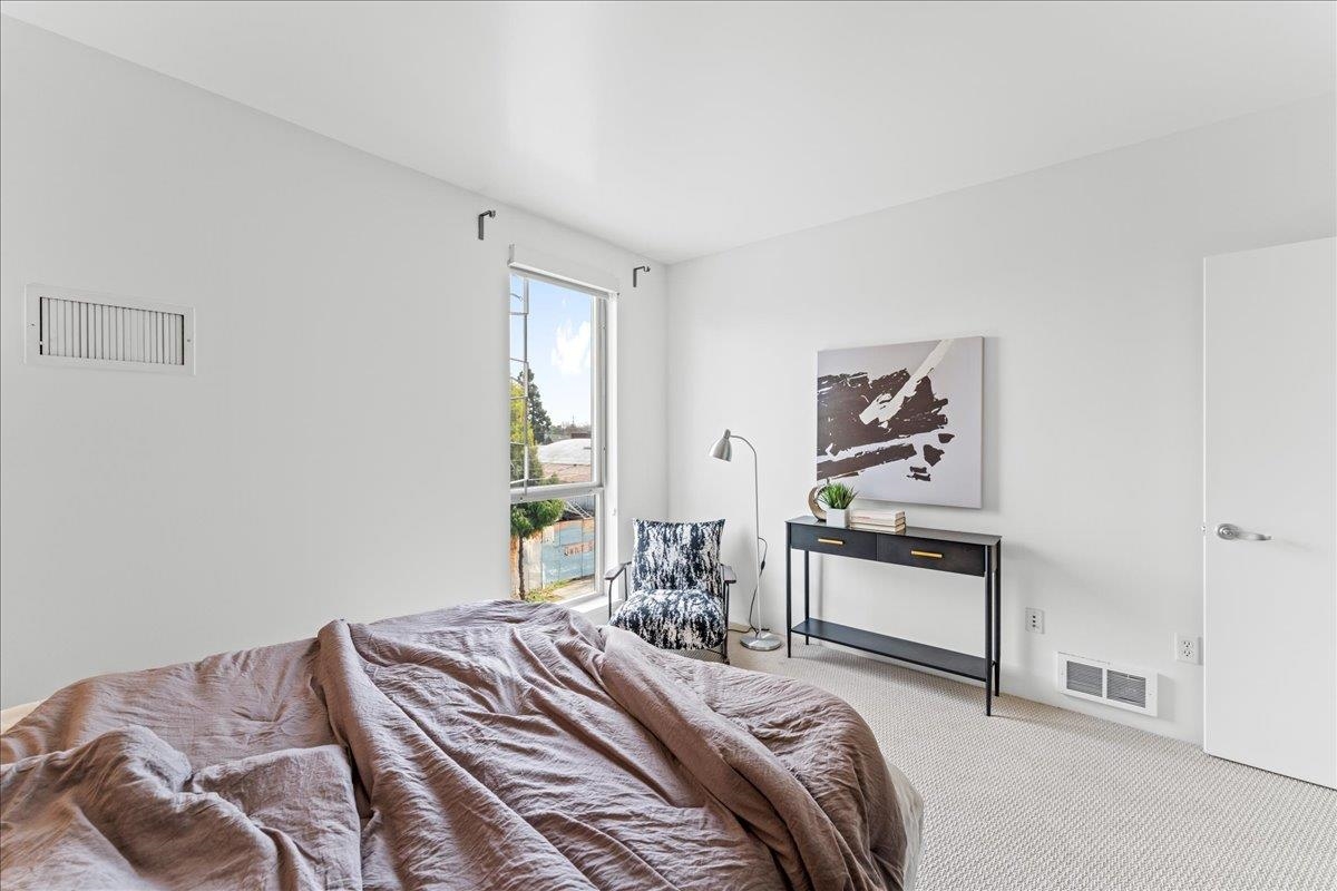 1201 Pine Street, Unit 365 Oakland, CA 94607 - Photo 25 of 33 a bedroom with a bed and a dresser