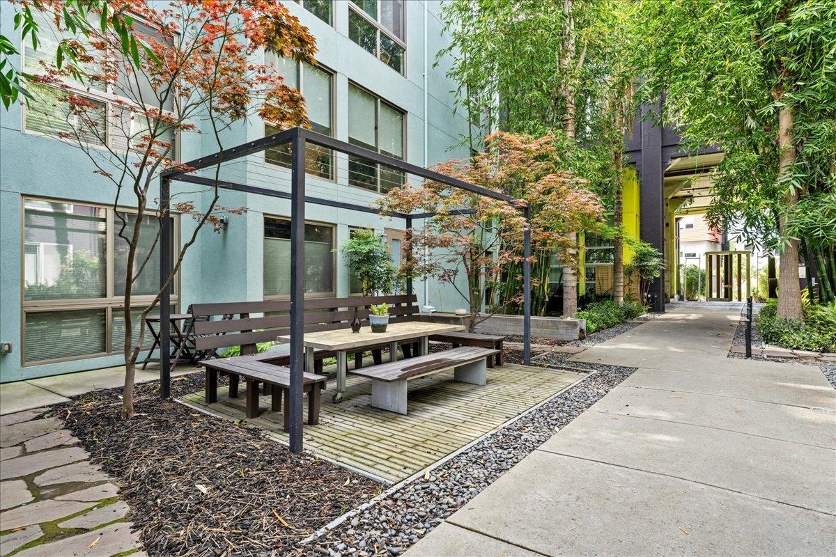 1201 Pine Street, Unit 365 Oakland, CA 94607 - Photo 28 of 33 a view of a dinning table and chairs in backyard of the house