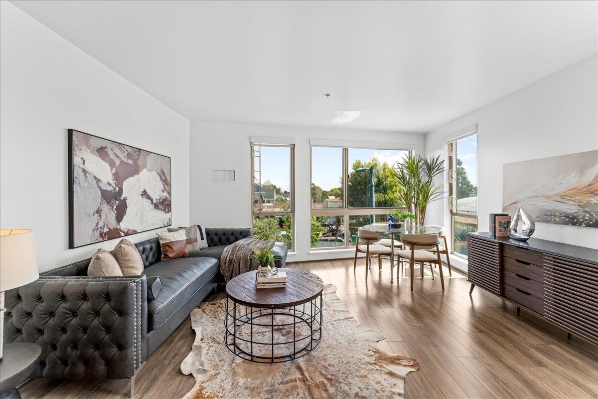 1201 Pine Street, Unit 365 Oakland, CA 94607 - Photo 5 of 33 a living room with furniture and a large window