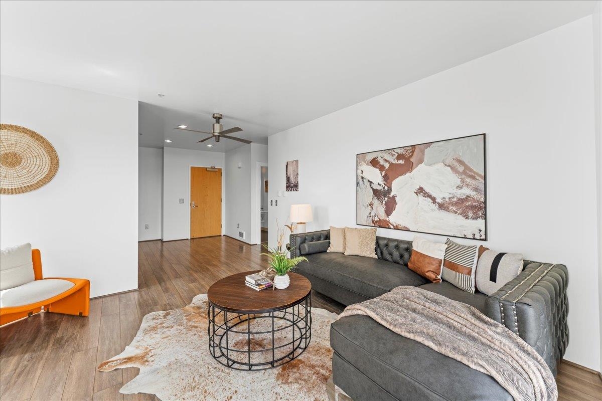 1201 Pine Street, Unit 365 Oakland, CA 94607 - Photo 8 of 33 a living room with furniture and wooden floor