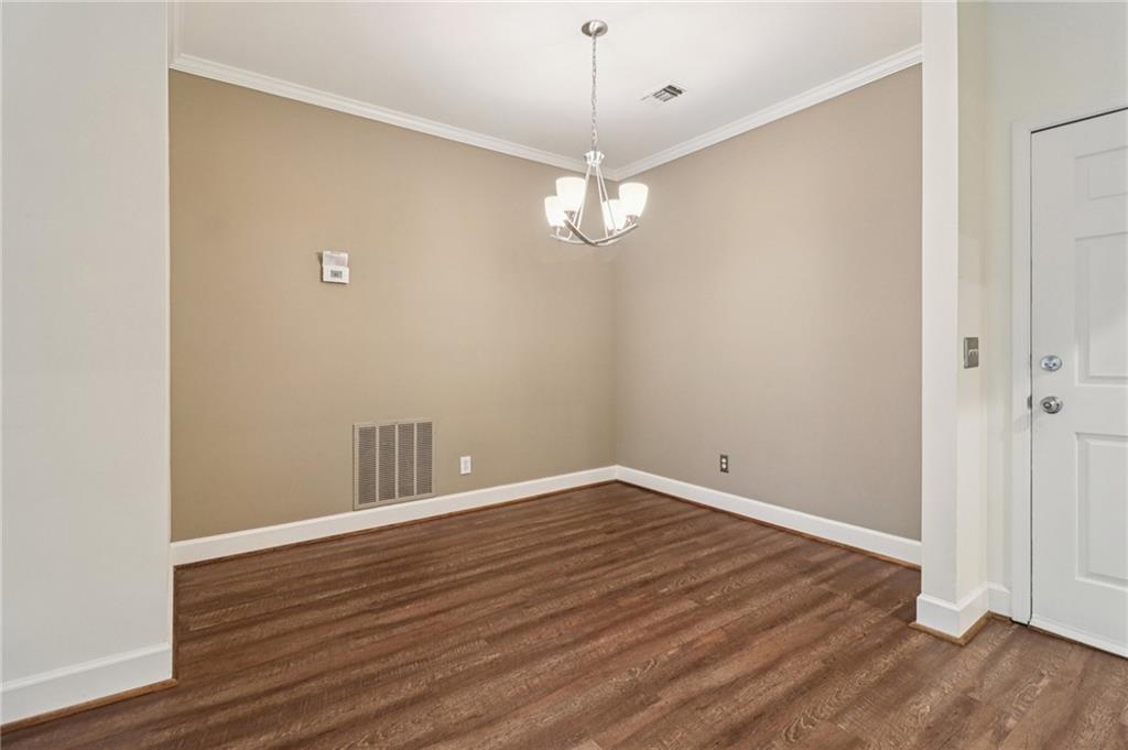 3071 Lenox Road Northeast, Unit 8 Atlanta, GA 30324 - Photo 11 of 50 a view of an empty room with wooden floor