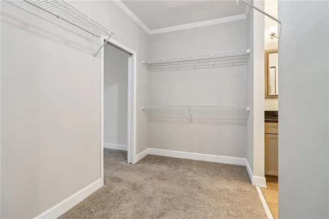 a bathroom with a granite countertop sink a toilet a mirror and shower