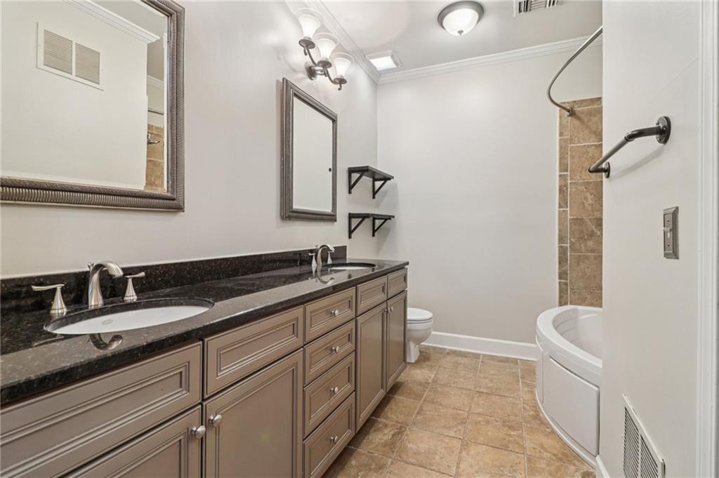 3071 Lenox Road Northeast, Unit 8 Atlanta, GA 30324 - Photo 26 of 50 a bathroom with a tub sink and mirror