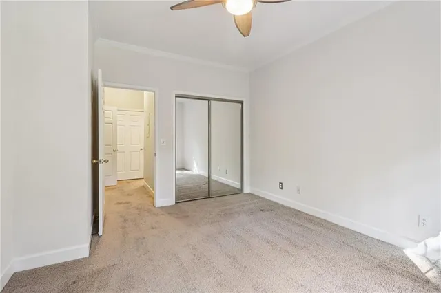 an empty room with windows and closet