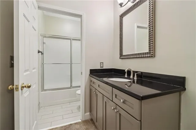 a bathroom with a glass shower door