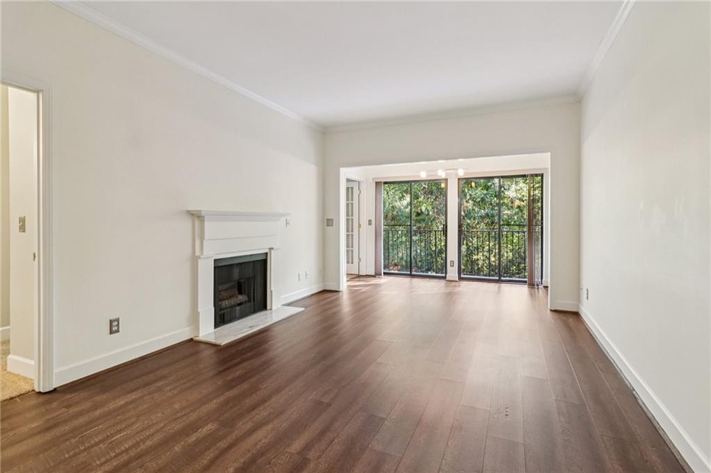 3071 Lenox Road Northeast, Unit 8 Atlanta, GA 30324 - Photo 7 of 50 a view of an empty room with wooden floor and a window