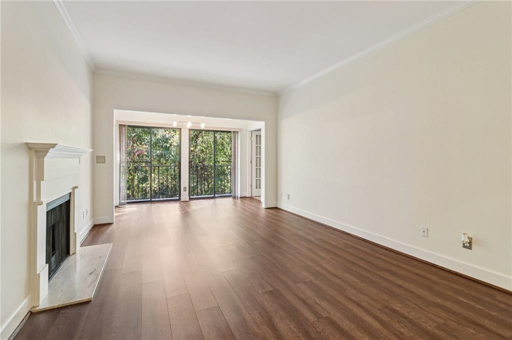 3071 Lenox Road Northeast, Unit 8 Atlanta, GA 30324 - Photo 8 of 50 a view of a livingroom with wooden floor and a fireplace
