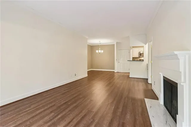 a view of a big room with wooden floor and a fireplace
