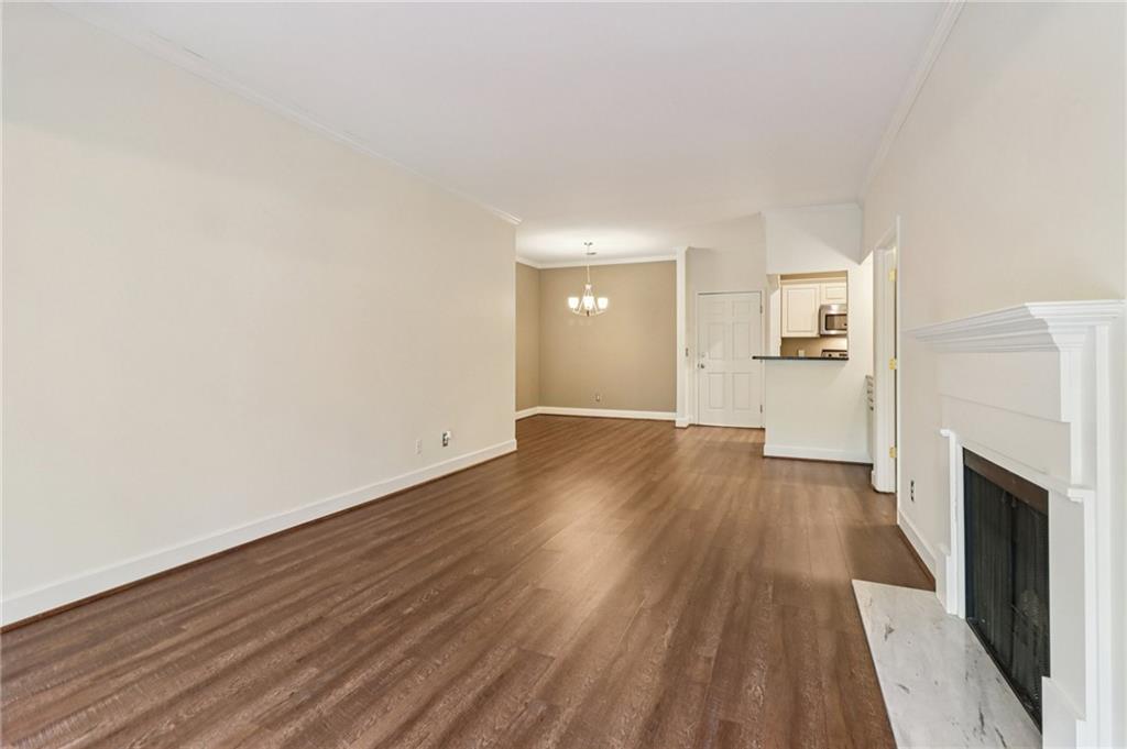 3071 Lenox Road Northeast, Unit 8 Atlanta, GA 30324 - Photo 9 of 50 a view of a big room with wooden floor and a fireplace