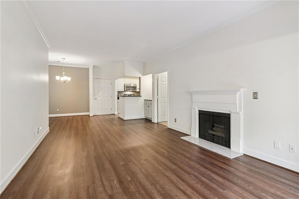 3071 Lenox Road Northeast, Unit 8 Atlanta, GA 30324 - Photo 10 of 50 a view of empty room with a fireplace and wooden floor