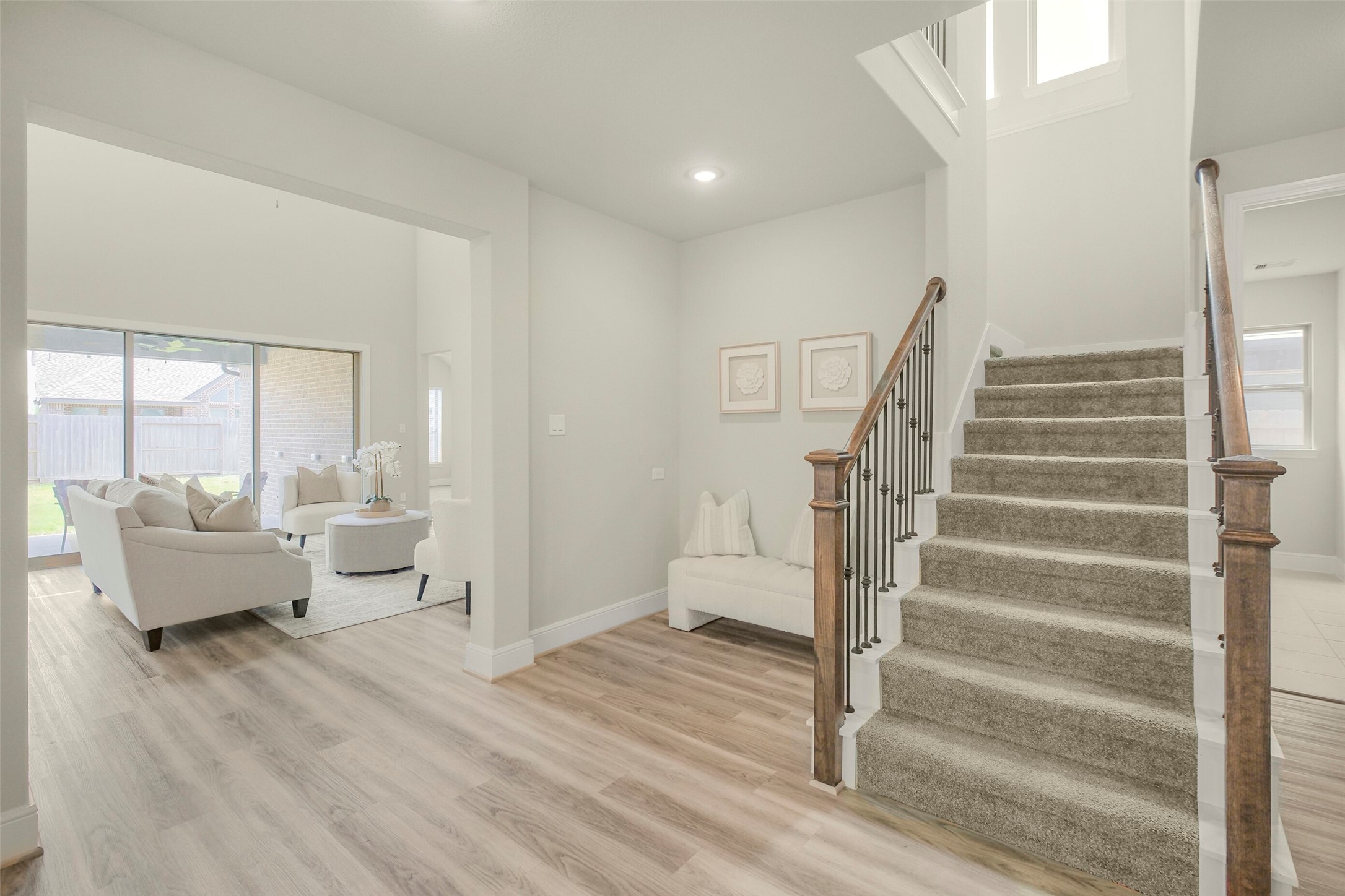 10514 Rigel Rdg Way Richmond, TX 77406 - Photo 13 of 50 Continue toward the back of the home and you'll start to get a glimpse of what's ahead—the spacious family room and that wall of glass leading to the backyard.