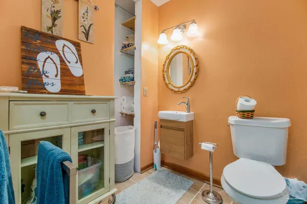 a white toilet sitting next to a bathroom sink