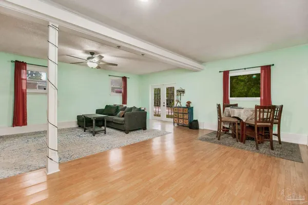 a living room with furniture and a wooden floor