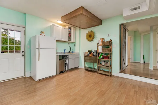 a kitchen that has a lot of cabinets and refrigerator