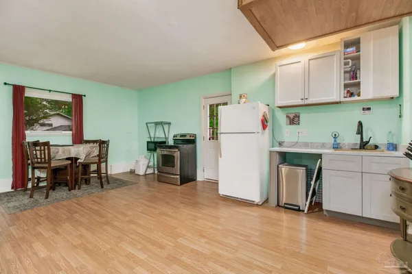 a kitchen with refrigerator cabinets and wooden floor
