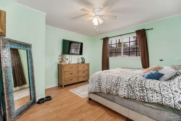 a bedroom with a bed and a tv on the dresser