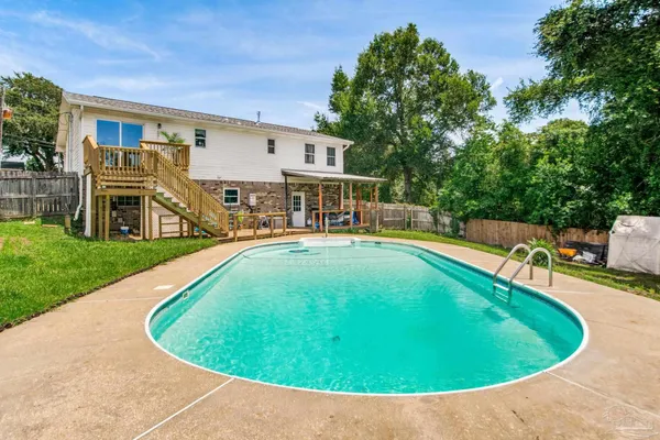 a view of a swimming pool with a lounge chairs