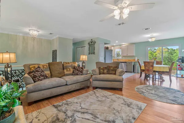 a living room with furniture and a chandelier