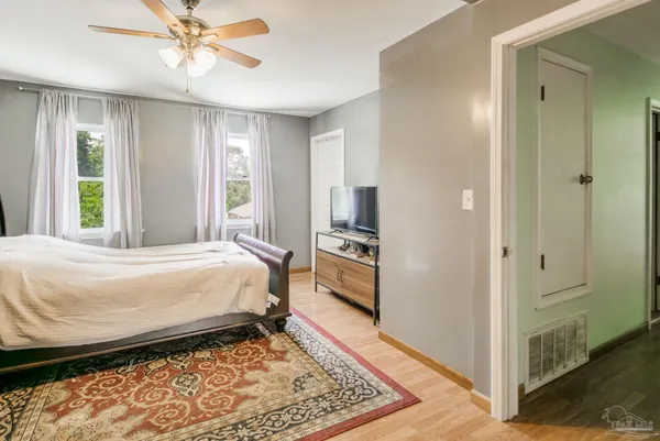 a bedroom with a bed and a chandelier