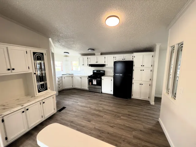 a kitchen with stainless steel appliances a refrigerator stove microwave and cabinets