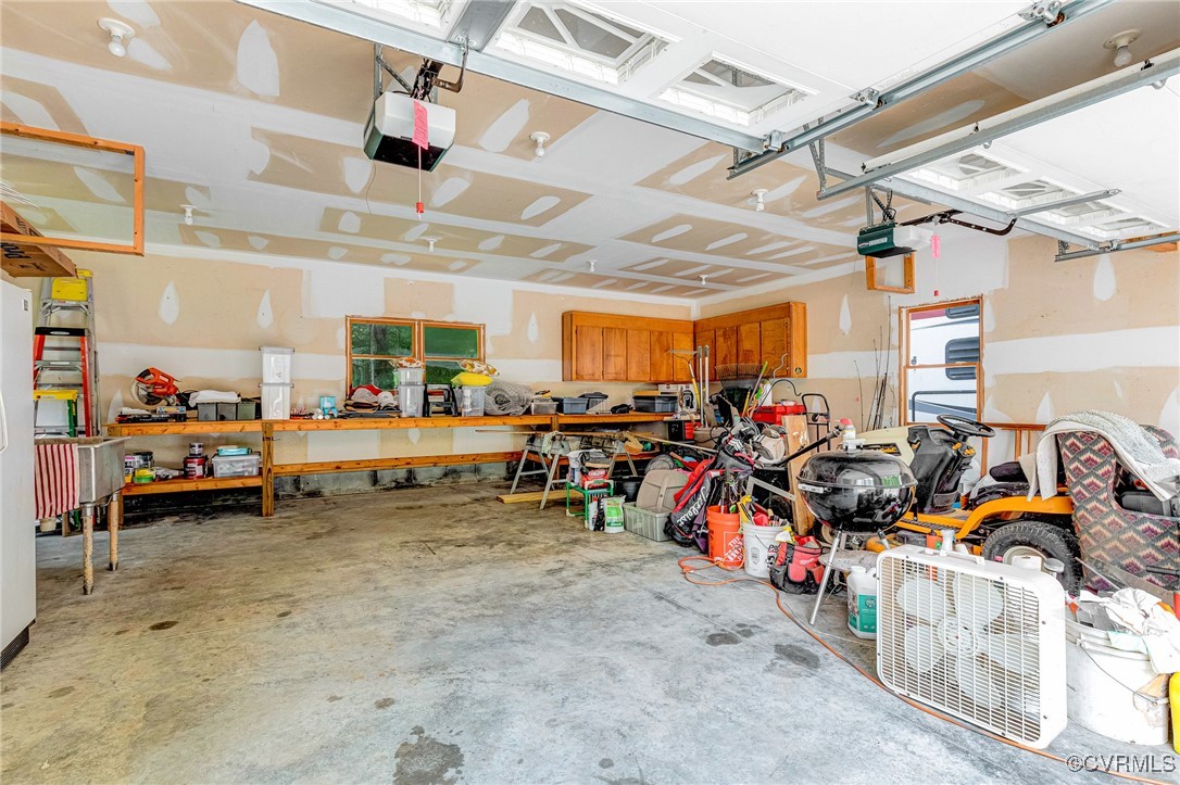 11384 Georgetown Road Mechanicsville, VA 23116 - Photo 33 of 49 2+ car garage with built in cabinets and work benc