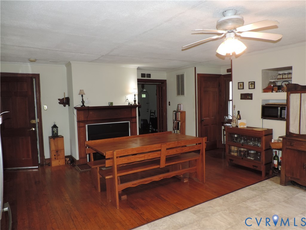 12262 Welling Hall Road Doswell, VA 23047 - Photo 3 of 42 a living room with furniture a flat screen tv and a fireplace