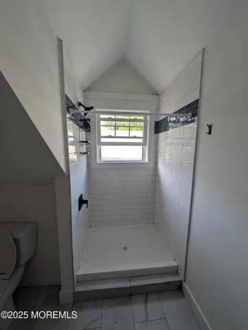 a bathroom with a glass shower door