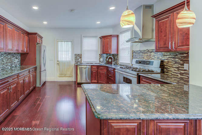 180 Hudson Avenue Red Bank, NJ 07701 - Photo 4 of 18 a kitchen with stainless steel appliances granite countertop wooden cabinets a stove and a sink