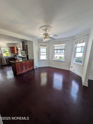 a view of a livingroom with furniture wooden floor and chandelier