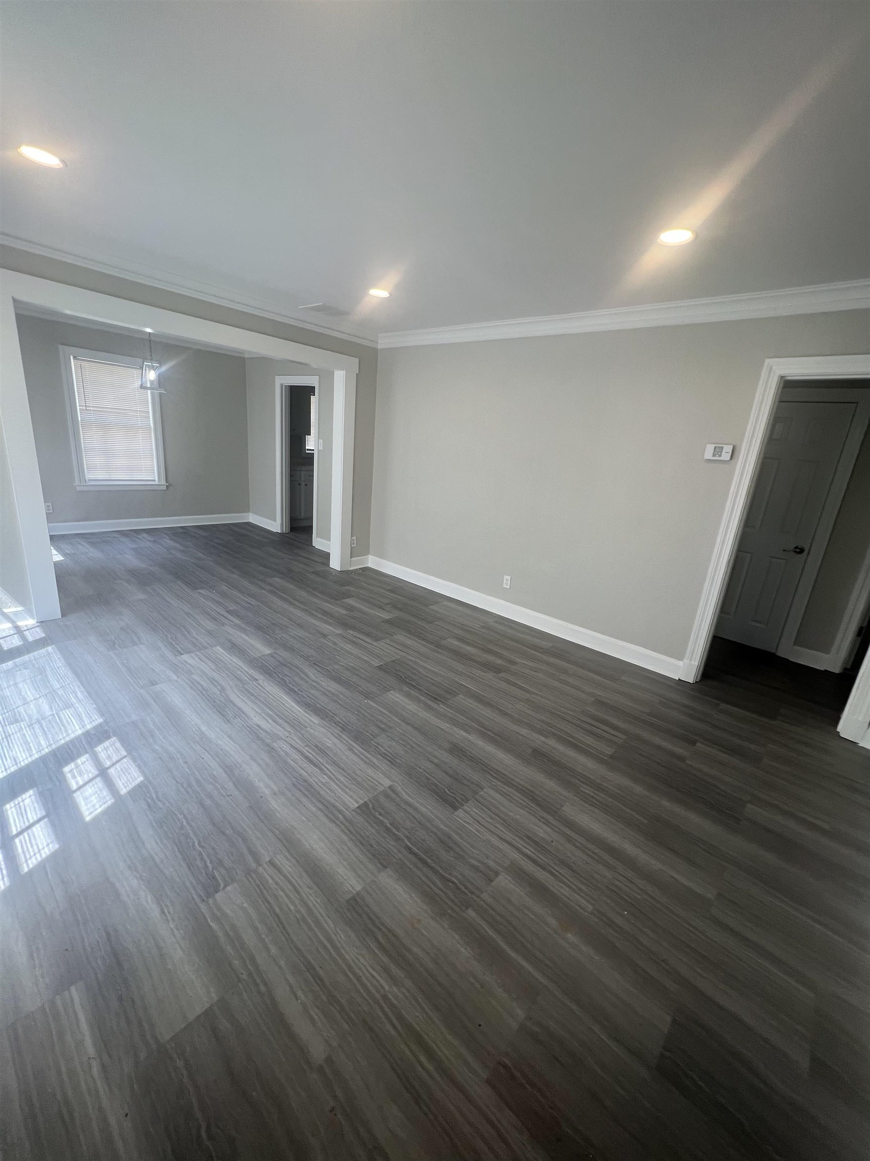 3578 Carrington Road Memphis, TN 38111 - Photo 2 of 11 an empty room with wooden floor and windows