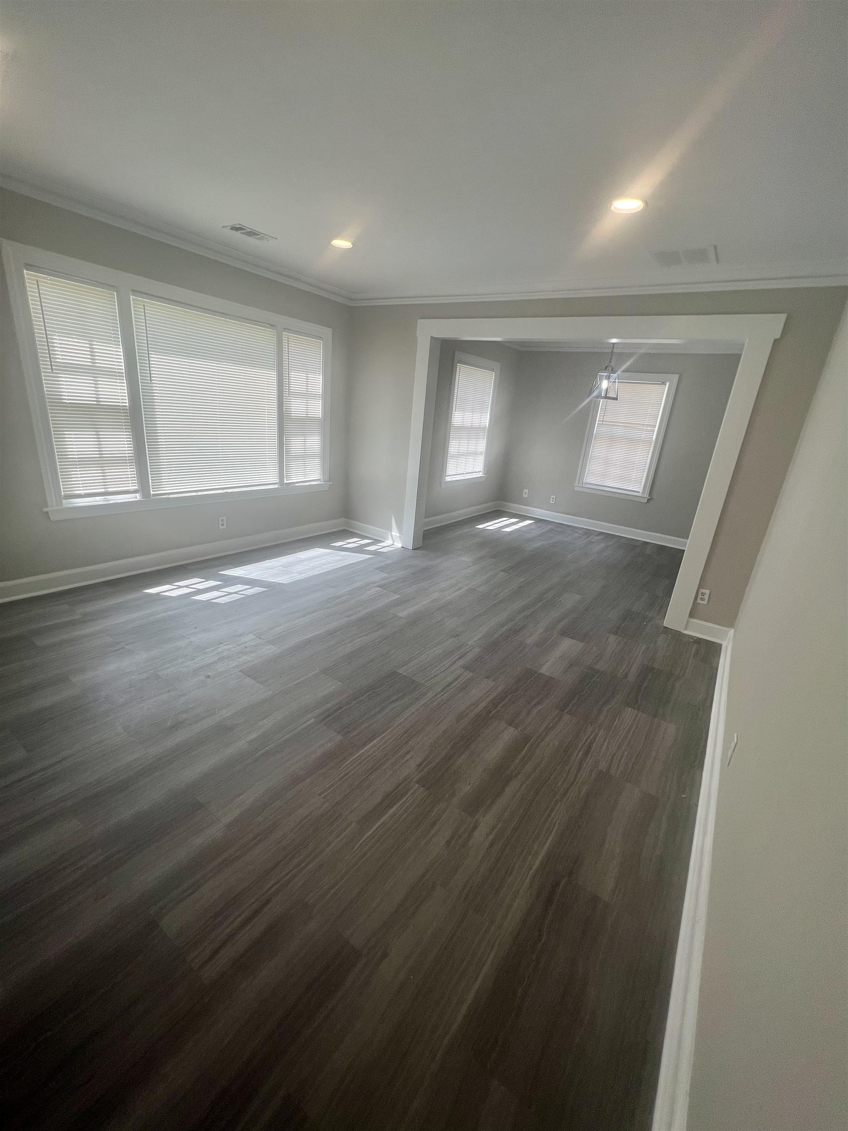 3578 Carrington Road Memphis, TN 38111 - Photo 4 of 11 an empty room with wooden floor and windows