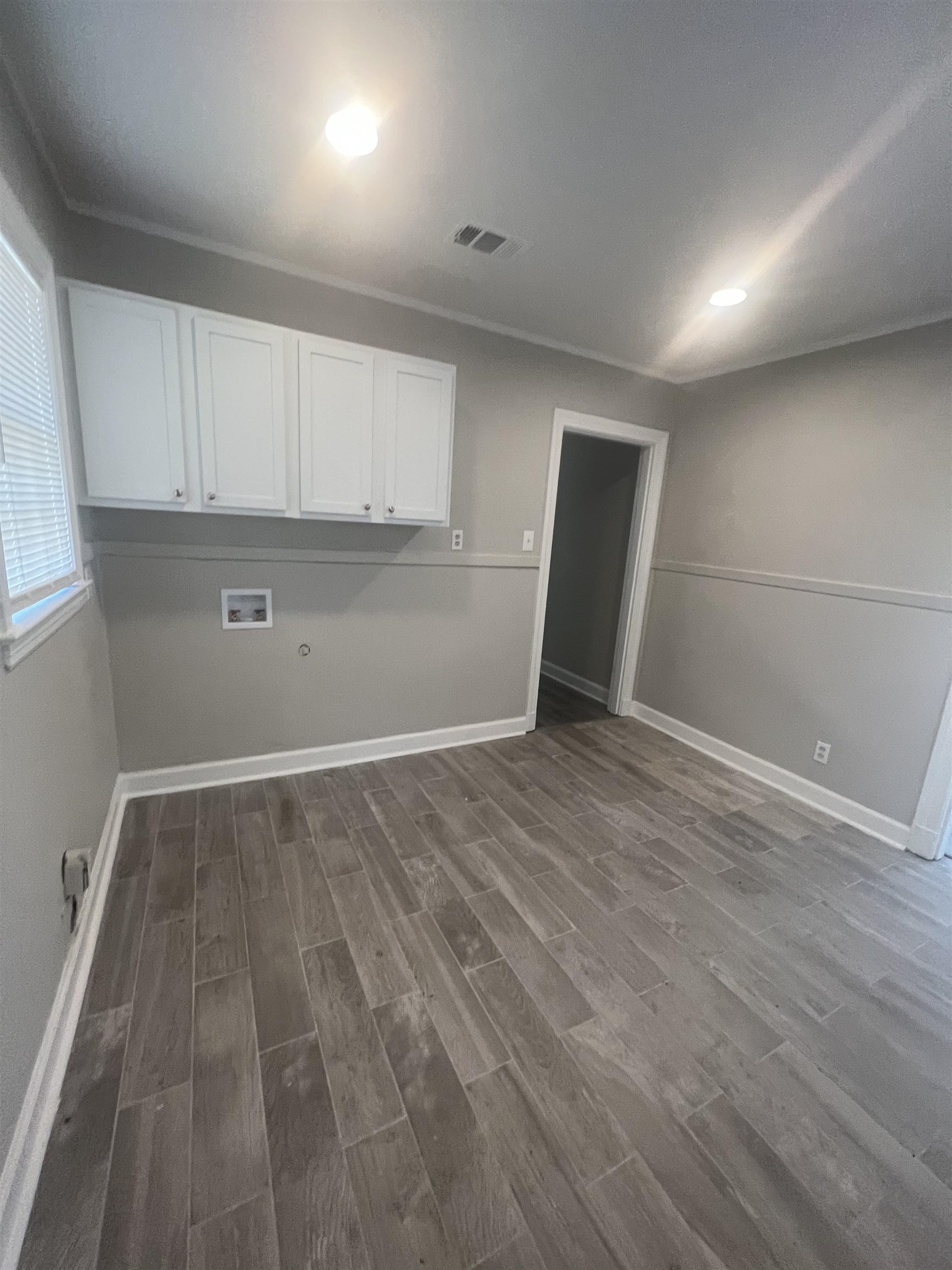 3578 Carrington Road Memphis, TN 38111 - Photo 5 of 11 an empty room with wooden floor and windows