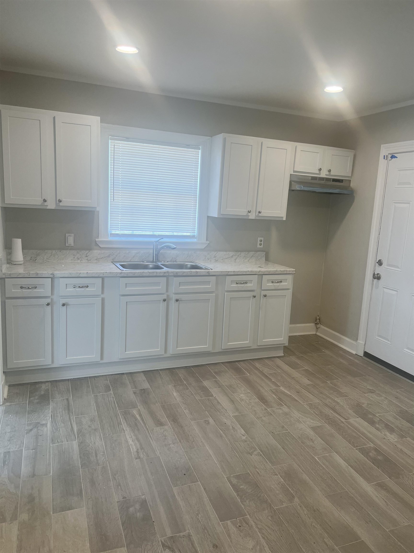 3578 Carrington Road Memphis, TN 38111 - Photo 7 of 11 a kitchen with stainless steel appliances granite countertop a stove a sink and white cabinets