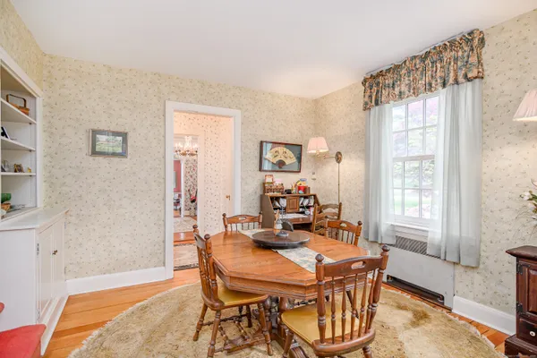 a dining room with furniture and window