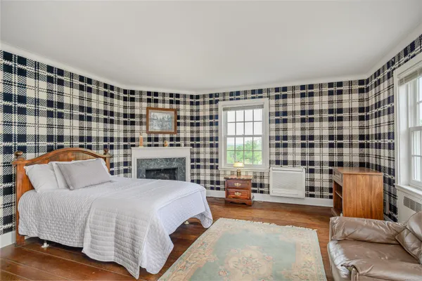 a bedroom with a bed and glass window