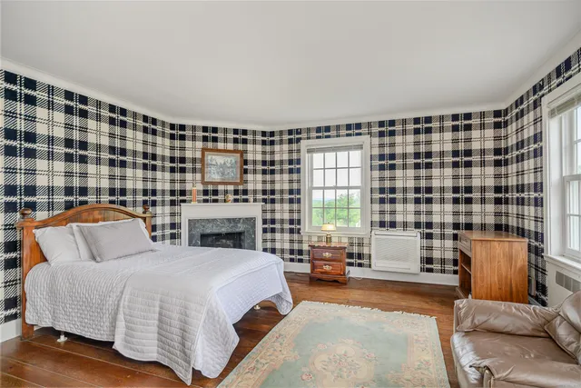 a bedroom with a bed and glass window