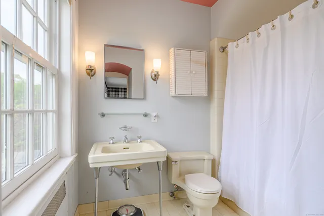 a bathroom with a sink toilet and mirror
