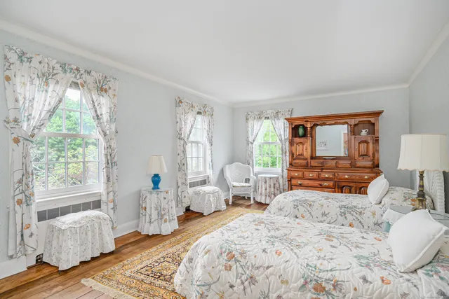 a bedroom with a large bed and large window