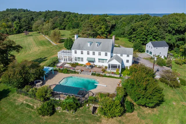 an aerial view of a house with garden space and street view
