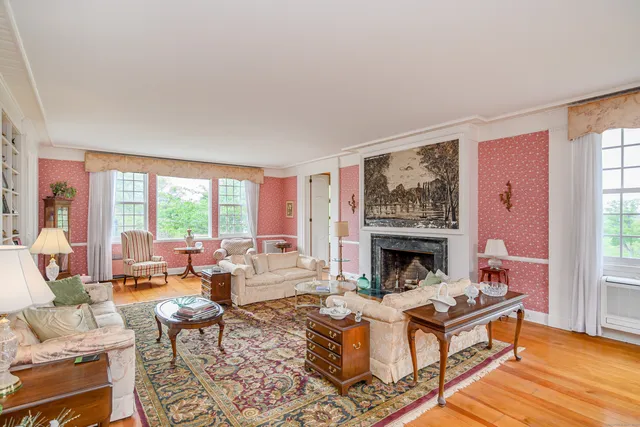 a living room with fireplace furniture and a fireplace