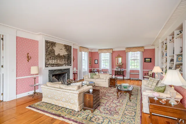 a living room with furniture large window and a fireplace