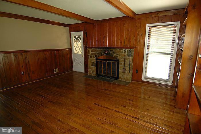 409 Highgate Terrace Silver Spring, MD 20904 - Photo 12 of 30 a view of an empty room with wooden floor and a window