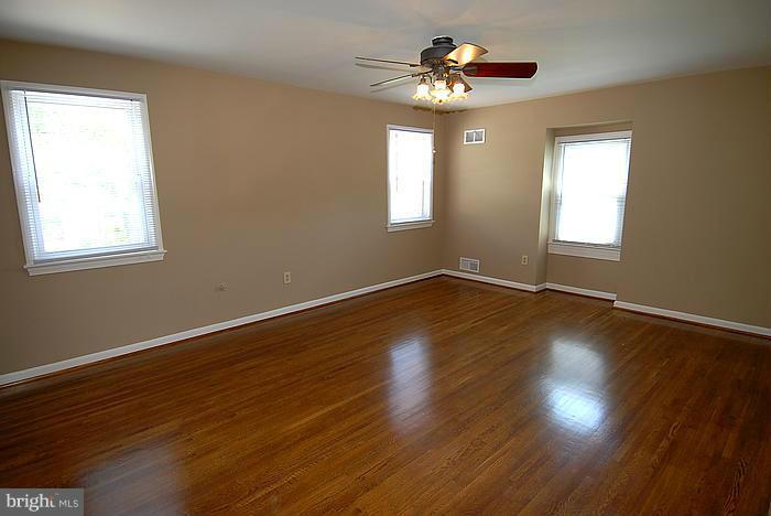 409 Highgate Terrace Silver Spring, MD 20904 - Photo 13 of 30 a view of an empty room with wooden floor and a window