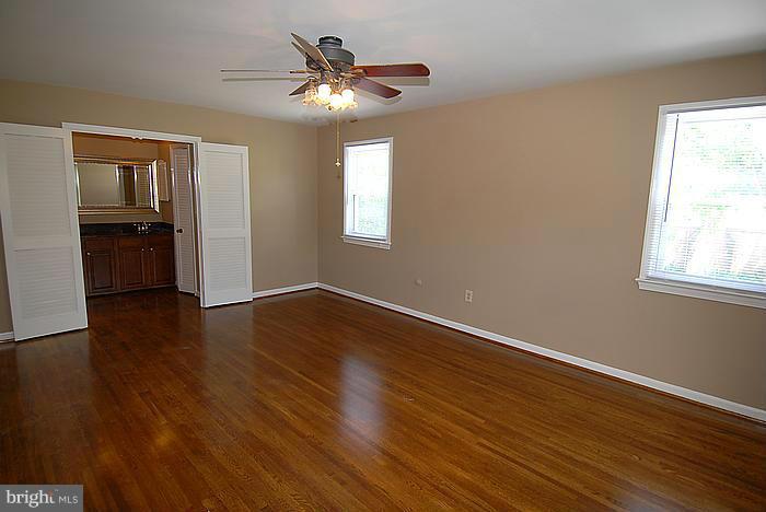 409 Highgate Terrace Silver Spring, MD 20904 - Photo 14 of 30 a view of an empty room with wooden floor and a window