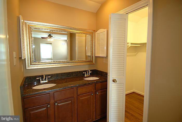 409 Highgate Terrace Silver Spring, MD 20904 - Photo 17 of 30 a bathroom with a sink a mirror and a shower