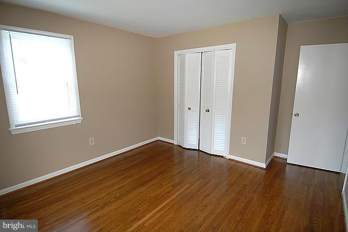409 Highgate Terrace Silver Spring, MD 20904 - Photo 18 of 30 a view of an empty room with wooden floor and a window