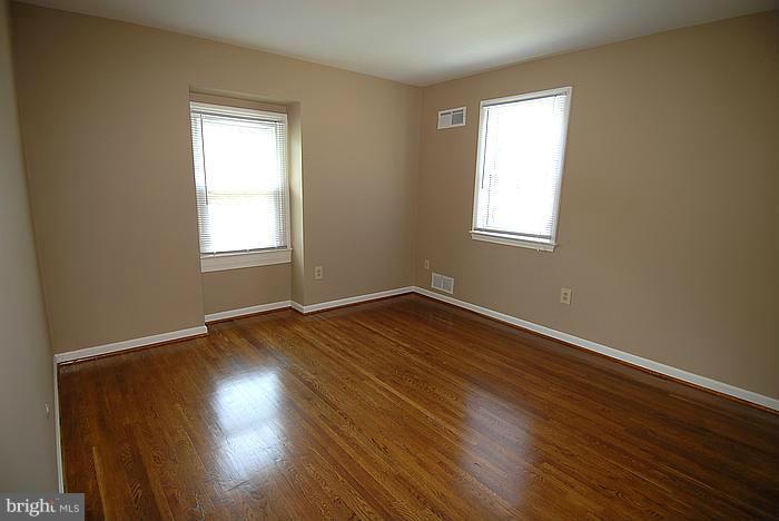 409 Highgate Terrace Silver Spring, MD 20904 - Photo 19 of 30 an empty room with wooden floor and windows