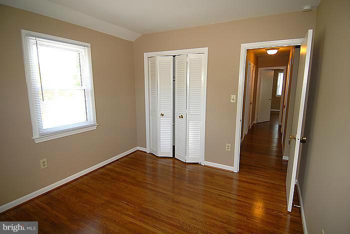 409 Highgate Terrace Silver Spring, MD 20904 - Photo 21 of 30 wooden floor in an empty room with a window
