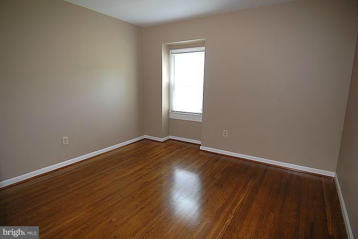 409 Highgate Terrace Silver Spring, MD 20904 - Photo 22 of 30 an empty room with wooden floor and windows